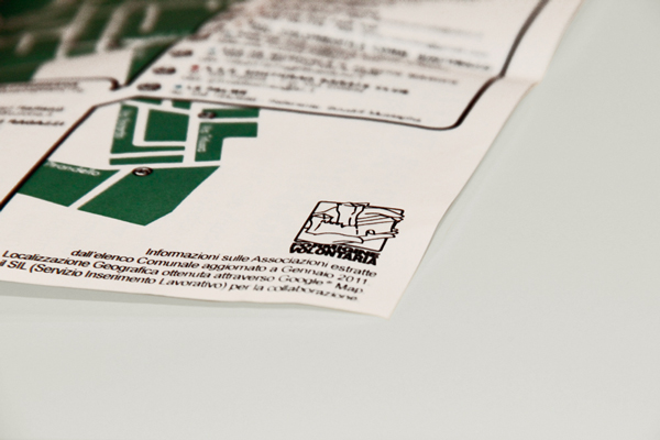 A detail of opened flier. The black and white logo is placed in the lower right corner of the paper, together with it some contact information of the project is provided.