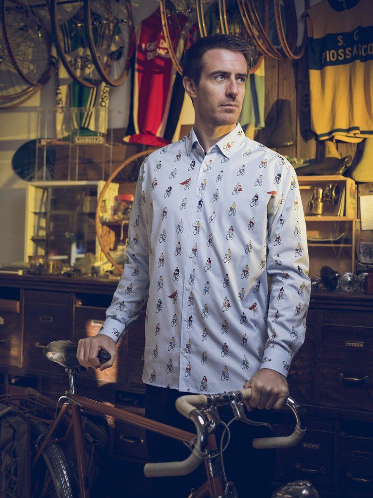 The Freddie Mercury Old Captain shirt worn by a model, who is posing in front of a classic race bike from the 60's. 